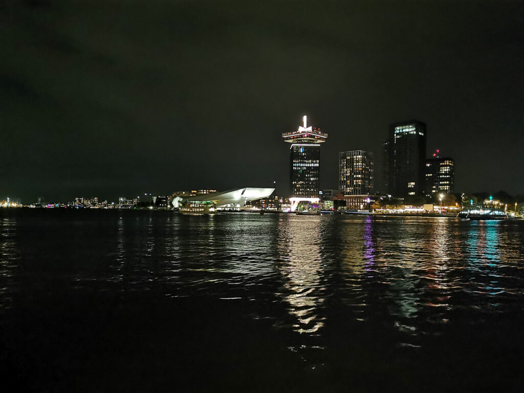 Dark night photo taken behind Amsterdam central station, looking over the water towards Noord